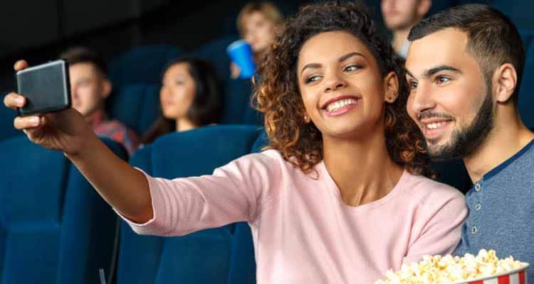 Happy couple eating popcorn