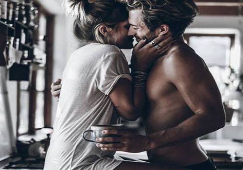 couple taking selfie in kitchen