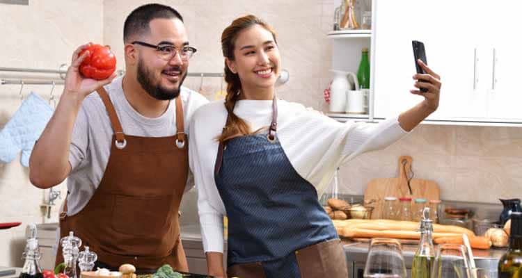 Couple taking selfie in kitchen