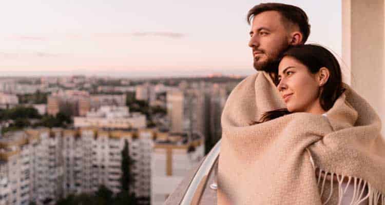 Couple cuddling in blanket