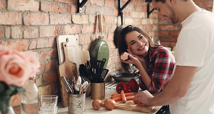 man helping his partner in kitchen