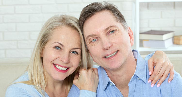 cheerful couple embrace