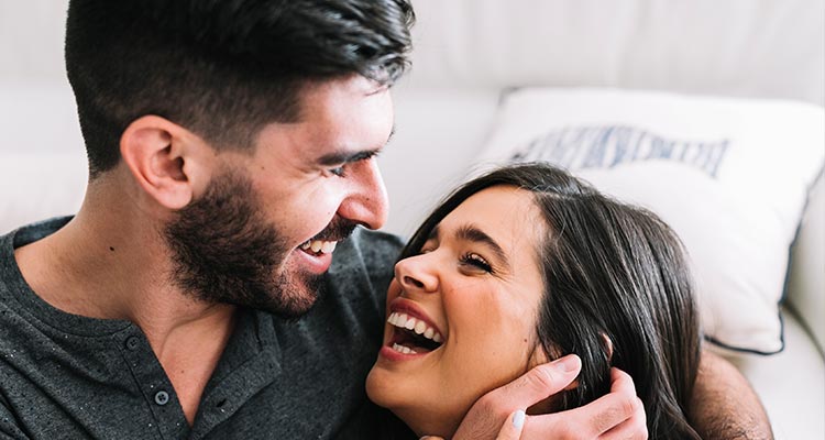 smiling young woman embracing laughing