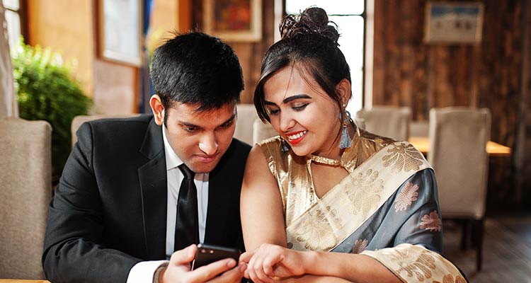 indian friends couple of woman in saree and man in suit