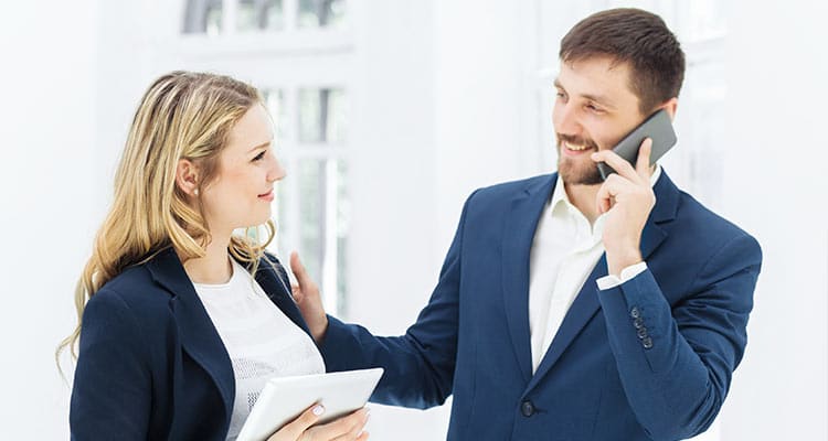 Happy women in office with co-worker