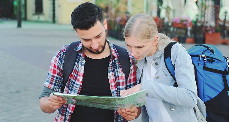 Couple looking in map while travelling 