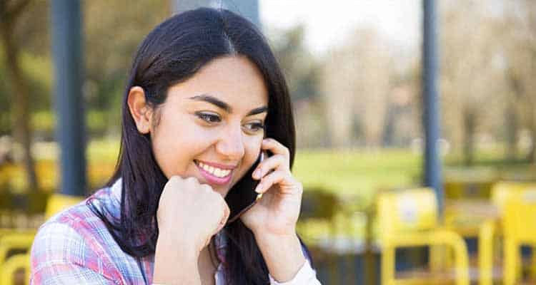 Young girl talking with his friend over phone call