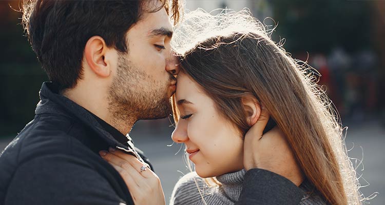man kiss woman on forehead