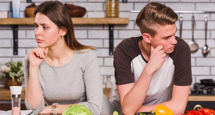 Upset young couple in quarrel in kitchen